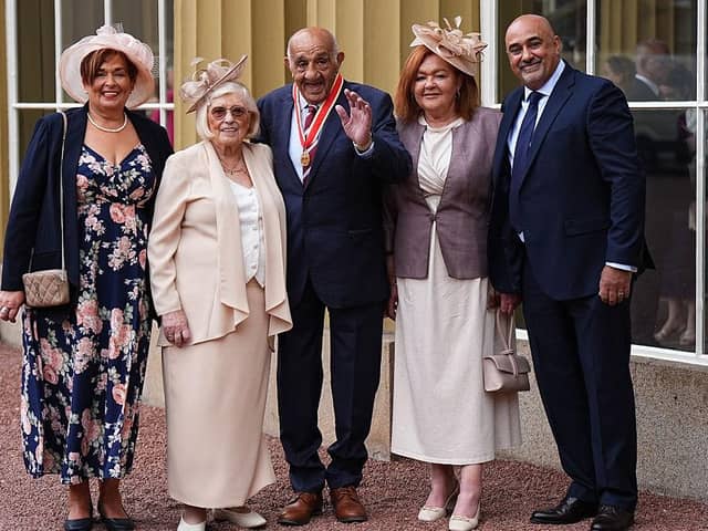 Sir Billy Boston stands with wife Joan, son Stephen and daughters Karen Murray and Christine Davies after receiving his knighthood
