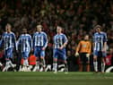 CARDIFF, UNITED KINGDOM - FEBRUARY 26: The Wigan Athletic players show their dejection during the Carling Cup Final match between Manchester United and Wigan Athletic at the Millennium Stadium on February 26, 2006 in Cardiff, Wales. (Photo by Phil Cole/Getty Images)