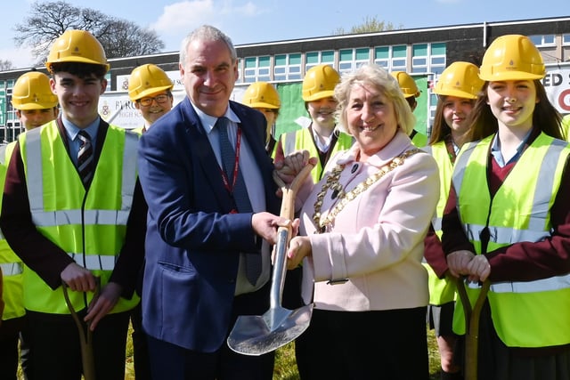 Headteacher Alan Birchall and the Mayor of Wigan Coun Marie Morgan, with pupils at the ground breaking ceremony, celebrating the start of construction of the new school building at Byrchall High School, Ashton-in-Makerfield.