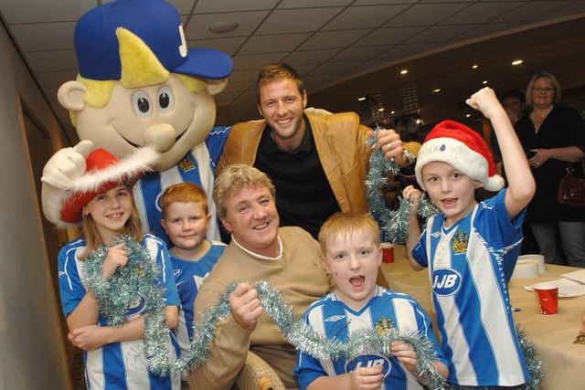 WELCOME TO TINSEL TOWN!...Young Wigan Athletic fans get up close to new manager Steve Bruce, goal keeper Carlo Nash and the cheecky chappie himself at JJ's World Christmas Party at The JJB Stadium.