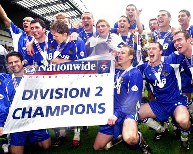 Latics celebrate with the Division 2 championship trophy after beating Barnsley 1-0 with a Tony Dinning goal  on Saturday 3rd of May, the last day of the 2002/2003 season. 