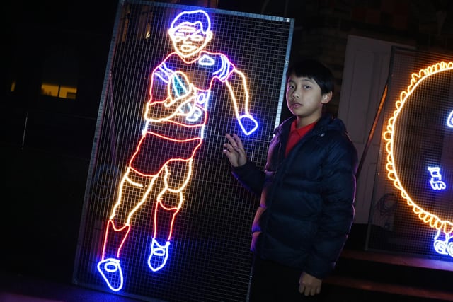 Arlo Wong, ten, with his drawing of rugby league legend Andy Farrell made into life-size neon.