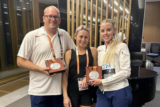 Keely Hodgkinson celebrates her World Championship silver medal with coaches Trevor Painter and his wife Jenny Meadows