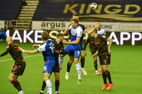 Charlie Wyke goes up for a header against Stoke