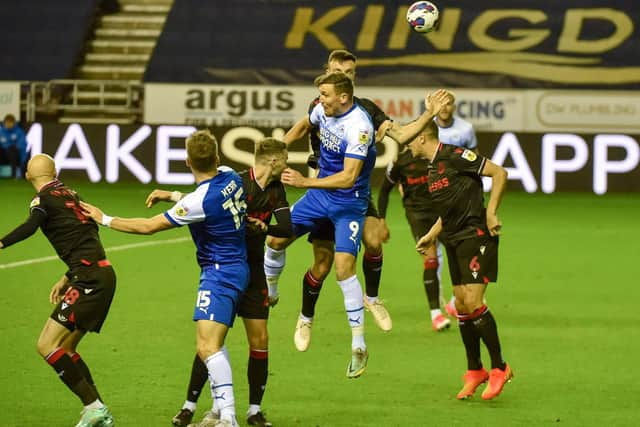 Charlie Wyke goes up for a header against Stoke