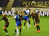 Charlie Wyke goes up for a header against Stoke