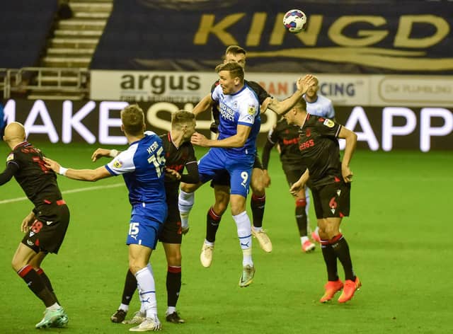 Charlie Wyke goes up for a header against Stoke