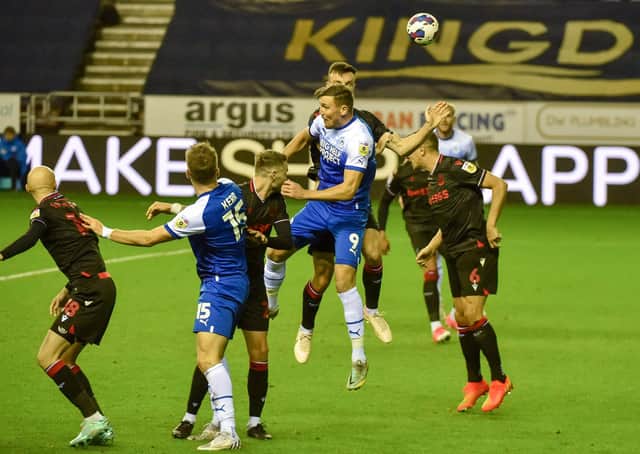 Charlie Wyke goes up for a header against Stoke