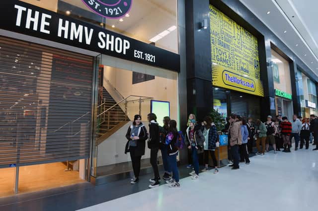 Excited shoppers queue outside the shop for the opening of The HMV Shop, Grand Arcade, Wigan