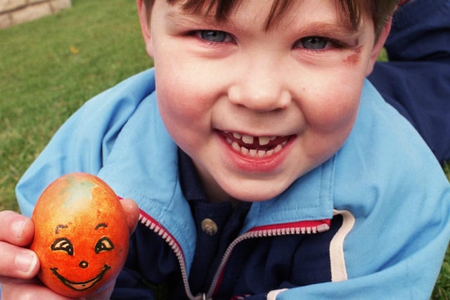 Jordan Wilson with his painted egg ready to roll down the slopes in Mesnes Park on Palm Sunday the 16th of April 2000.