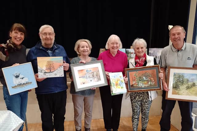 Members of Wrightington Art Group with some of their paintings