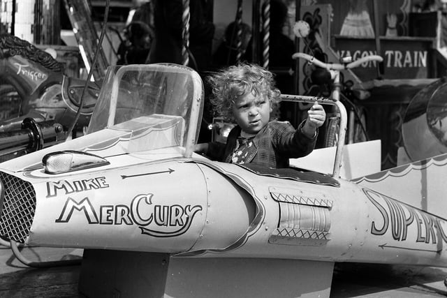 RETRO 1972  - Summer fun in Wigan's Mesnes Park with fairground rides depicting the TV shows of the era ie Wagon Train, Lone Ranger's  horse Trigger, and Mike Mercury's Supercar.