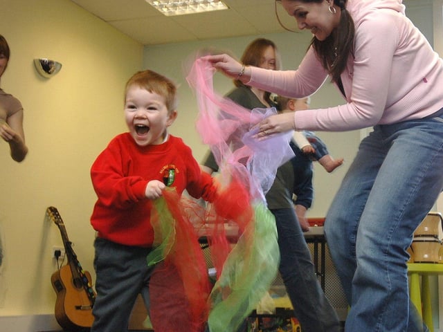Louisa Cadman, owner of Pipsqueak, music for pre-school children and grown-ups, plays a tickling game with a group of youngsters and parents at The Pier Centre at Today's Community Church, Pottery Road, Wigan Pier
