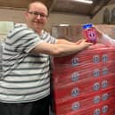 Chris Winnard (left) accepts a jar of Uncle Joe's Mint Balls from John Winnard (no relation) at the Wm Santus and Co factory in gratitude for his cheery new song about the company