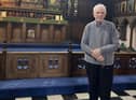 John Collier pictured by the font where he was christened in St Andrew's church, Wigan