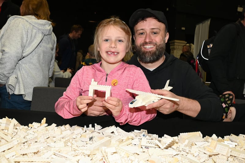 BLACKPOOL - 08-04-23  Lego fans enjoyed workshops, games, stalls and displays at Blackpool Brick Festival, held at the Winter Gardens, Blackpool.  Mark Taylor and Amber, six, enjoy building with Lego.