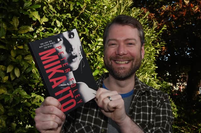 Wigan author Peter Foley, with his second novel, Mika Ito.