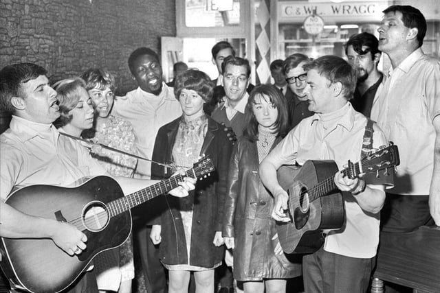Customers join in a sing song with the Spinners folk group after they opened Dawsons music shop in Hallgate in 1967.