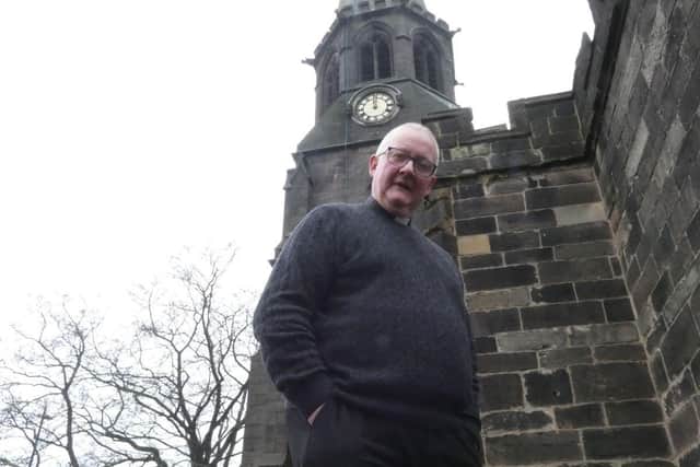 The Reverend Andrew Holliday outside St Wilfrid's Church in Standish
