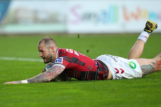 ST HELENS, ENGLAND - APRIL 01:  Zak Hardaker of Wigan Warriors dives over the line to score their third try during the Betfred Super League match between Wigan Warriors and Wakefield Trinity at Totally Wicked Stadium on April 01, 2021 in St Helens, England. Sporting stadiums around the UK remain under strict restrictions due to the Coronavirus Pandemic as Government social distancing laws prohibit fans inside venues resulting in games being played behind closed doors. (Photo by Alex Livesey/Getty Images)