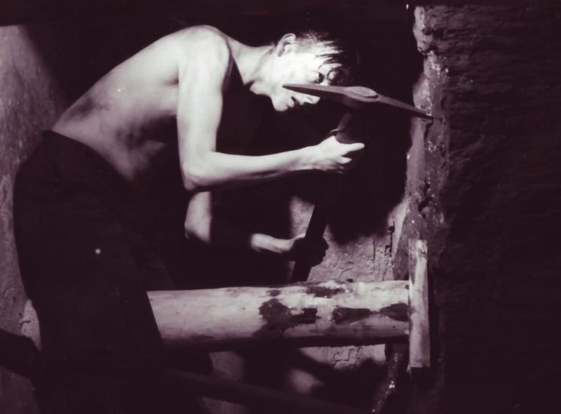An actor depicting life in the mines in Wigan in The Way We Were centre at Wigan Pier in 1986.