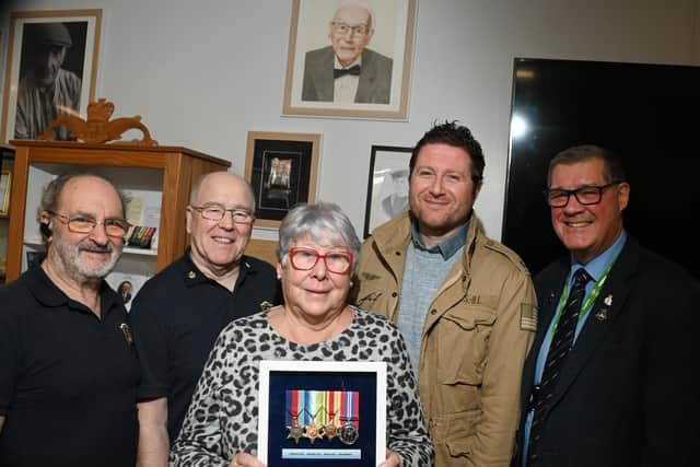 Relatives of the late Wigan veteran Harry Melling, are presented with medals and replicas are put on display, along with other information celebrating the veteran at Wigan Armed Forces Community HQ, Wigan.  From left: Ray Armstrong and Richard Thompson who made the display cabinet, Eileen Melling (niece of Harry), Matthew Melling (his great-nephew) and Charlie Neve, Commander Royal Navy - retired