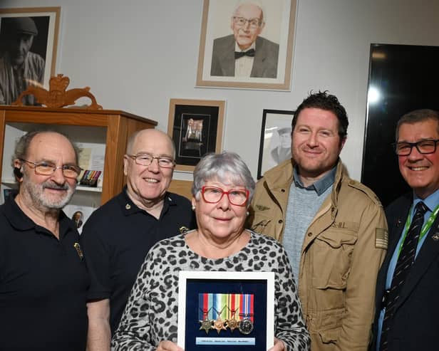 Relatives of the late Wigan veteran Harry Melling, are presented with medals and replicas are put on display, along with other information celebrating the veteran at Wigan Armed Forces Community HQ, Wigan.  From left: Ray Armstrong and Richard Thompson who made the display cabinet, Eileen Melling (niece of Harry), Matthew Melling (his great-nephew) and Charlie Neve, Commander Royal Navy - retired
