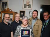 Relatives of the late Wigan veteran Harry Melling, are presented with medals and replicas are put on display, along with other information celebrating the veteran at Wigan Armed Forces Community HQ, Wigan.  From left: Ray Armstrong and Richard Thompson who made the display cabinet, Eileen Melling (niece of Harry), Matthew Melling (his great-nephew) and Charlie Neve, Commander Royal Navy - retired