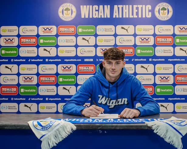 Matteo Spinelli puts pen to paper at the Brick Community Stadium