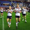 Mikey Lewis (left) and Ethan Havard (right) applaud the England fans after a win over Samoa at the Brick Community Stadium in 2024