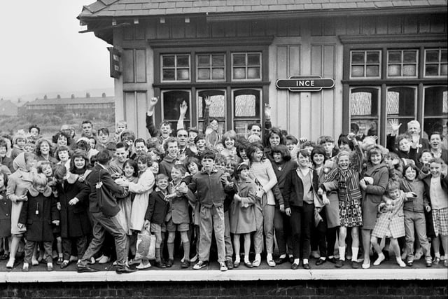 A crowded platform at Ince railway station as a happy crowd wait for the train to take them on a day trip in the 1960s.