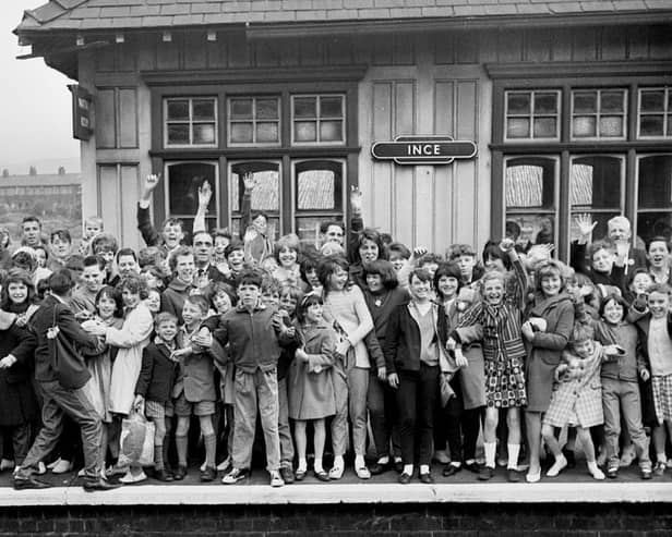 A crowded platform at Ince railway station as a happy crowd wait for the train to take them on a day trip in the 1960s.