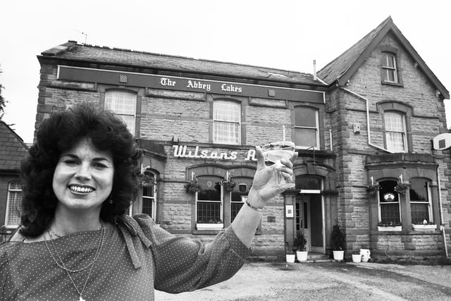 Wendy George, who was Miss Great Britain in 1969, celebrates being landlady of the Abbey Lakes Hotel in Orrell in July 1985.