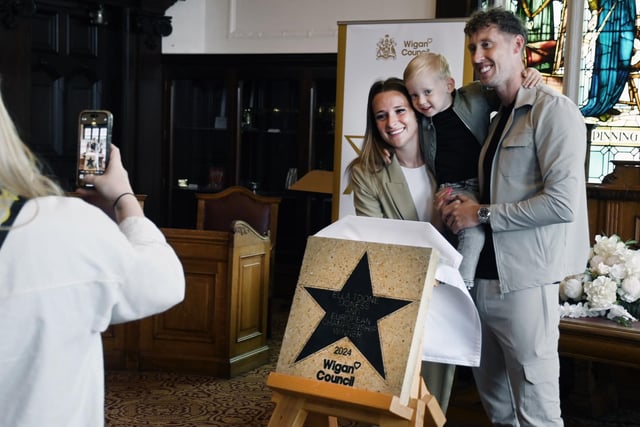 Football champion Ella Toone, Lioness and European Championship Winner, pictured with family and friends at a ceremony to present her Wigan Council star, placed outside Leigh Town Hall.