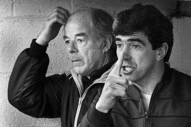 Wigan Athletic's new manager Bryan Hamilton points the way with trainer Kenny Banks scratching his head during the match against Bournemouth in the Division 3 clash at Springfield Park on Saturday 30th of March 1985. Latics lost the game 1-2 with Paul Jewell scoring their goal.