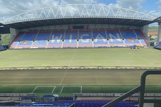 The pitch maintenance is already under way at Wigan Athletic