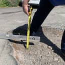 The pothole on Greenland Avenue measures around six inches deep.