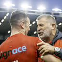 England coach Shaun Wane (r) congratulates Harry Smith after victory over Tonga.