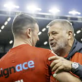 England coach Shaun Wane (r) congratulates Harry Smith after victory over Tonga.