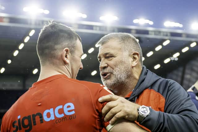 England coach Shaun Wane (r) congratulates Harry Smith after victory over Tonga.