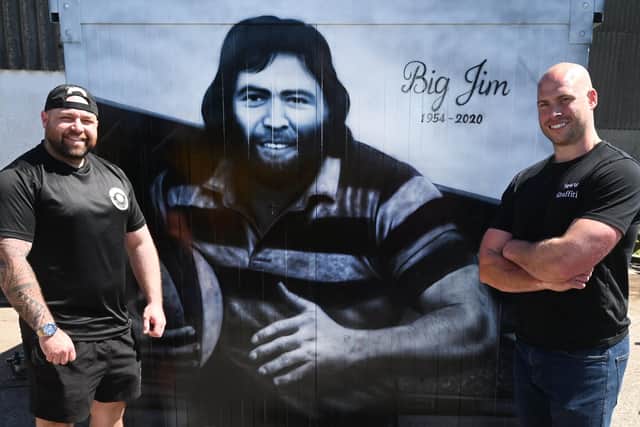 From left, Alex Melling, owner of Baldy's Pies, commissioned Scott Wilcock, right,  known as Snow Graffiti, to create a tribute to his dad, Jim Melling, who was a rugby pro and an inspiration to Alex