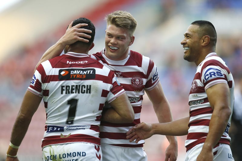 French is congratulated by Morgan Smithies and Willie Isa after scoring his fourth of the half.