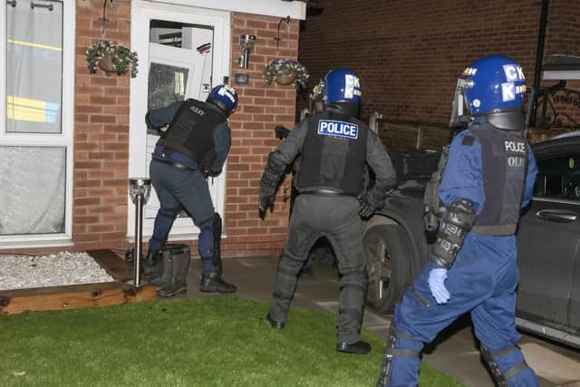 Police carry out a dawn raid in Wigan