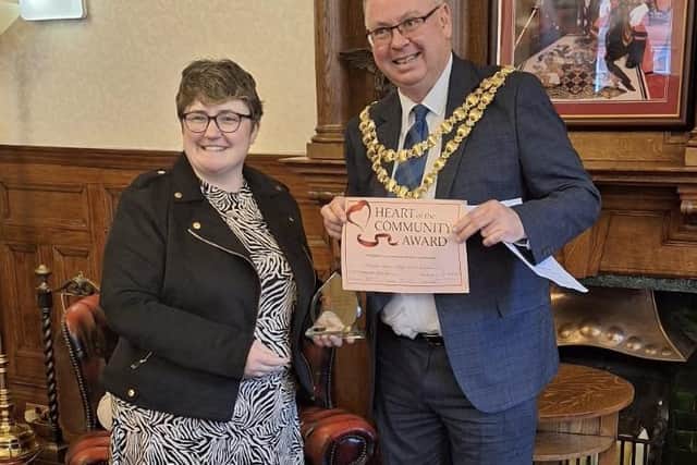 Rachel Heyden receives the Heart of the Community Award from Mayor of Wigan Coun Kevin Anderson