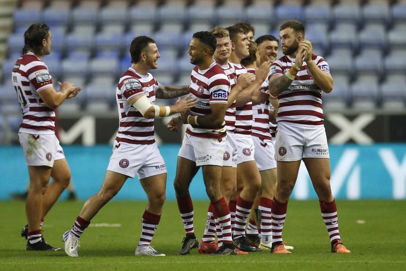 Wigan celebrate their 60-0 victory over Hull FC at full time
