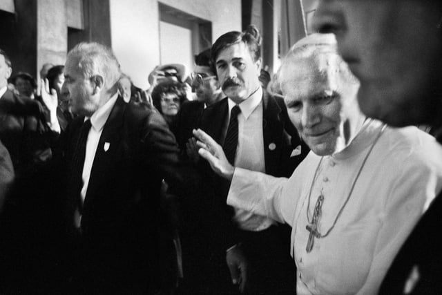 Memory from photographer Frank Orrell - The closest I got to the Pope as he left the cathedral, flanked by nervous security men.  He looked me straight in the eye and I'm sure he thought I was an assassin!  Photographers were allocated fixed point positions for the visit and I was in the choir stall high up.  From where I was I couldn't get a decent close up picture so as Pope John Paul was leaving the cathedral I left my position and gradually edged along an aisle with my wide angle lens and managed to get a couple of quick snaps whilst being jostled by security men.
