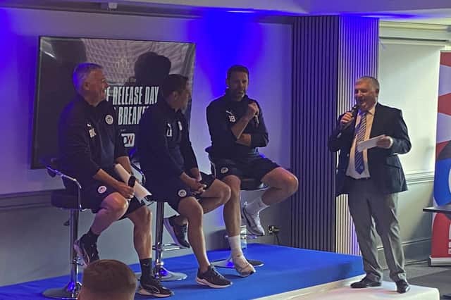 The Latics management team discover the fixtures for the new campaign at the DW Stadium