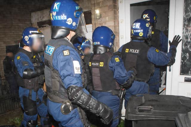 Police officers at one of the properties in Wigan borough where a drugs warrant was executed