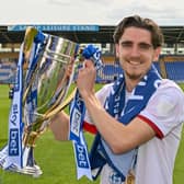 Tom Bayliss celebrates with the League One title