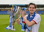 Tom Bayliss celebrates with the League One title